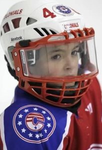 A kid wearing a hockey helmet